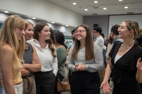 Students talk in a group. 