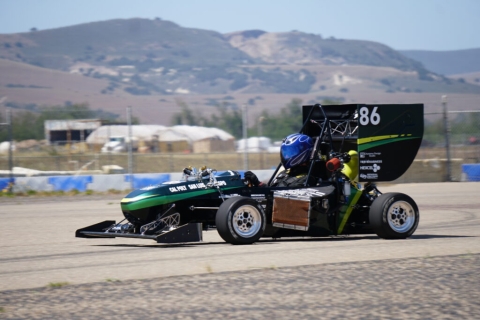 Tommy Bordeaux, a finance student, driving a Cal Poly Formula race car.