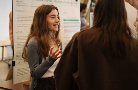 Student explaining her research at a SURP Symposium
