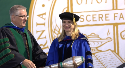 Cal Poly President Jeffrey D. Armstrong honors Kim Westermann during the 2025 spring commencement.