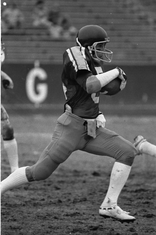 Robbie Martin, running downfield with a football during a Cal Poly game