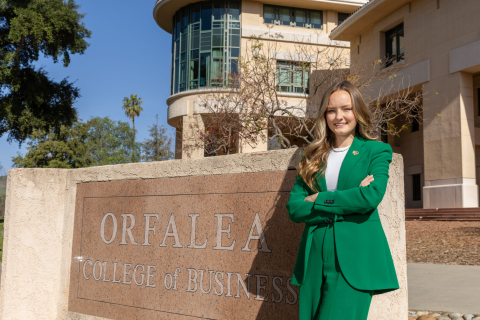 Ashleigh Spragins poses in front of the Orfalea College of Business sign
