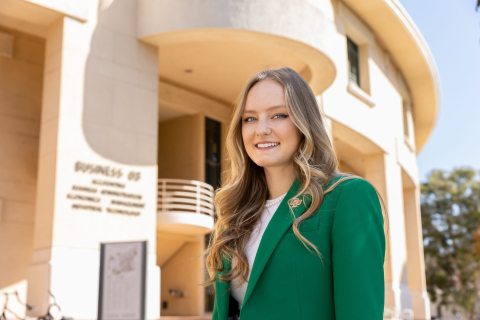 Ashleigh Spragins poses for a photo in front of the Business building