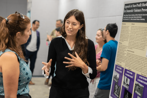 A student explains her research project during the SURP Symposium