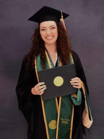 Lily Steinberg poses in her graduation cap and gown