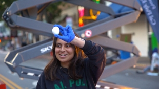 A Poly Pack member shows the crowd an intact egg