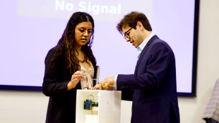 Two students demonstrate a medical device