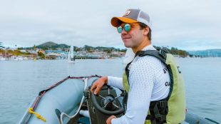 Cal Poly business student Nathan Briar steers a boat in Morro Bay Harbor