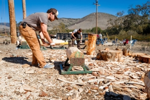 Nate Mirizzi measuring a log in a logging competition.