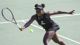 Kim Bhunu aims to hit a forehand during a tennis match