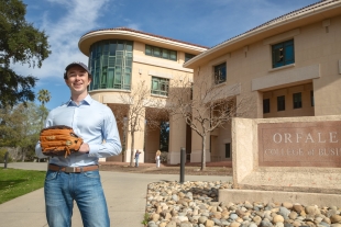 Brandon Williams poses in front of the Cal Poly Business building
