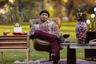 Adam Kemp sitting in leather chair outside