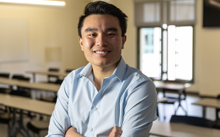 Portrait of Randy Tran in an empty classroom