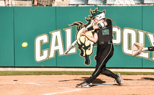 Caroline Allman, hitting a softball during a Mustangs game