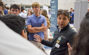 A recruiter talks to students at a Career Fair