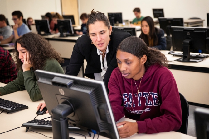 Katya Vasilaky assisting students in her economics class