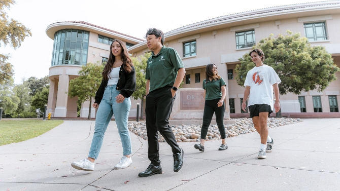 Group of students walking away from Orfalea building