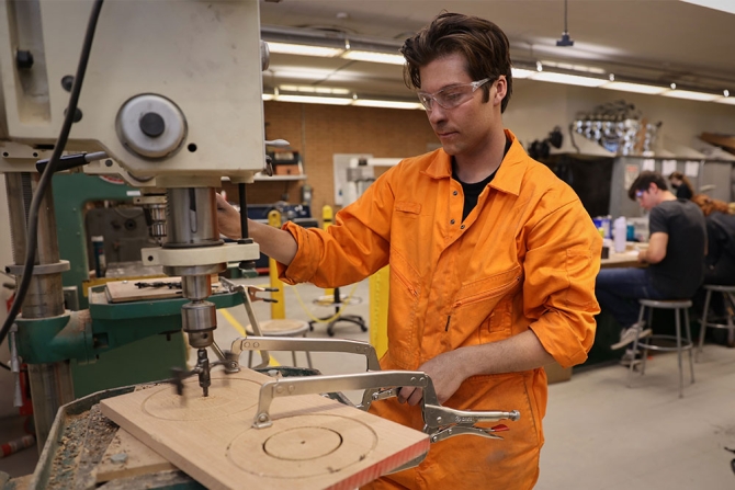 Student working on a drill press