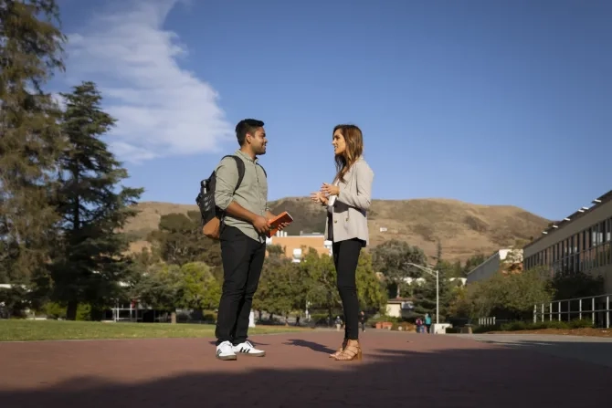 Student talking to faculty member