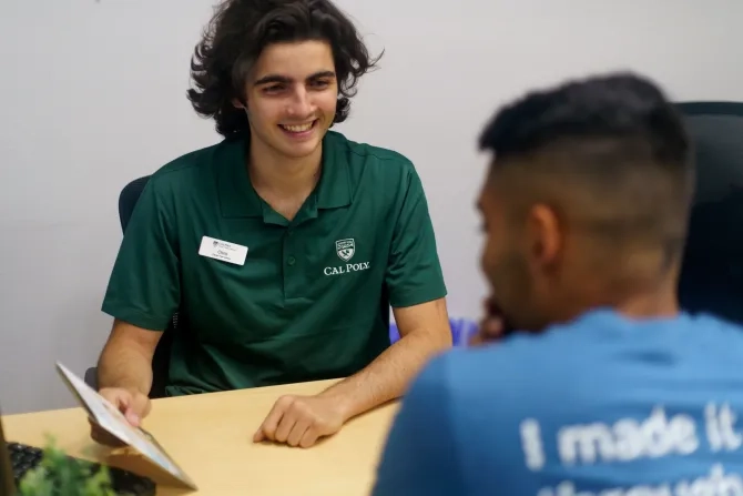 Student getting resources from staff