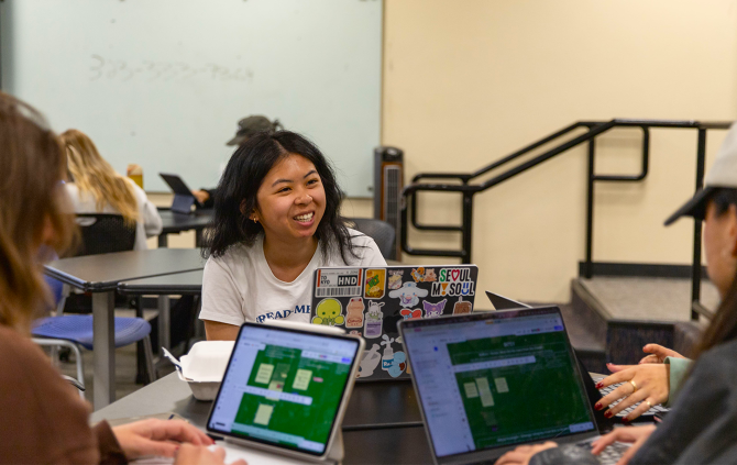 Marketing students collaborate at a table
