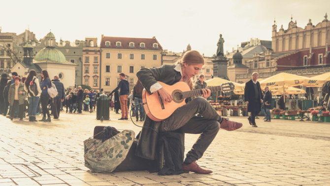 Flamenco guitarist playing in a public area