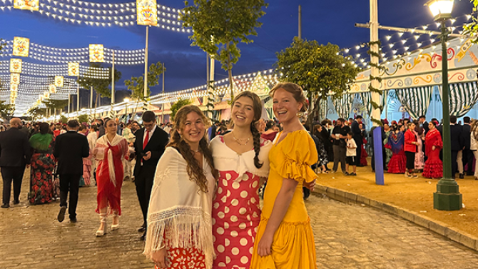 Three girls pose for photo at a festival