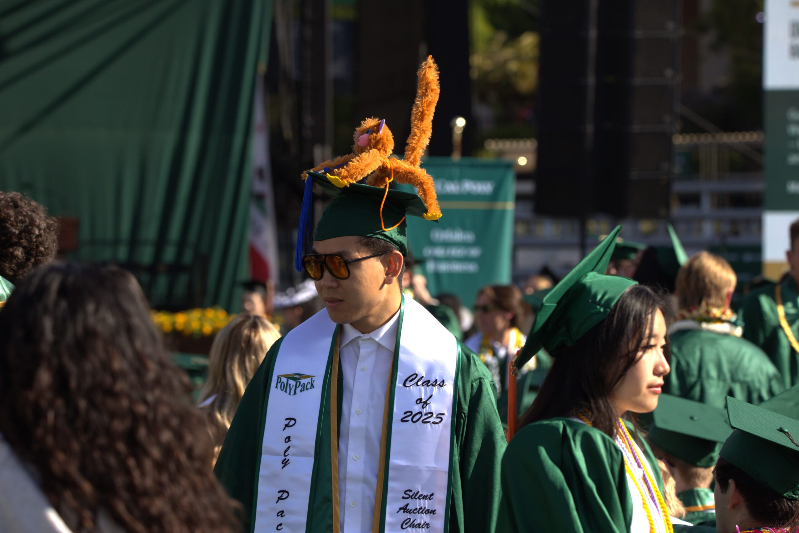 A student wears a funny animal on his graduation cap