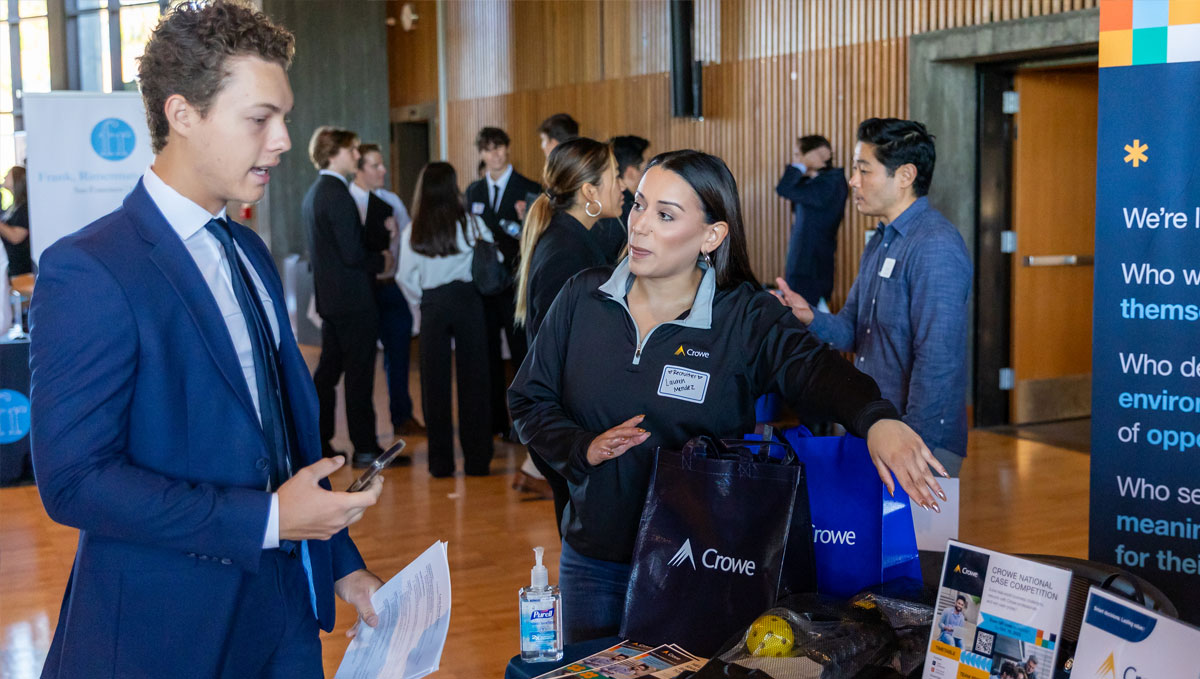 Student speaks with corporate partner