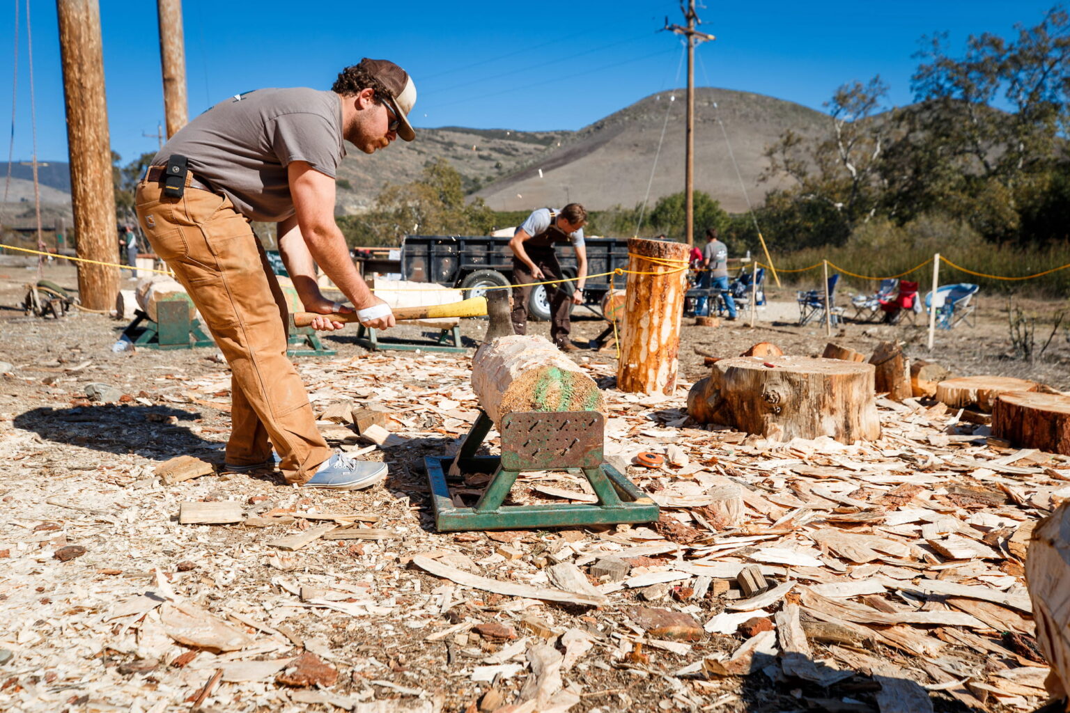 Recent Orfalea College of Business graduate Nate Mirizzi chops wood during his final logging competition