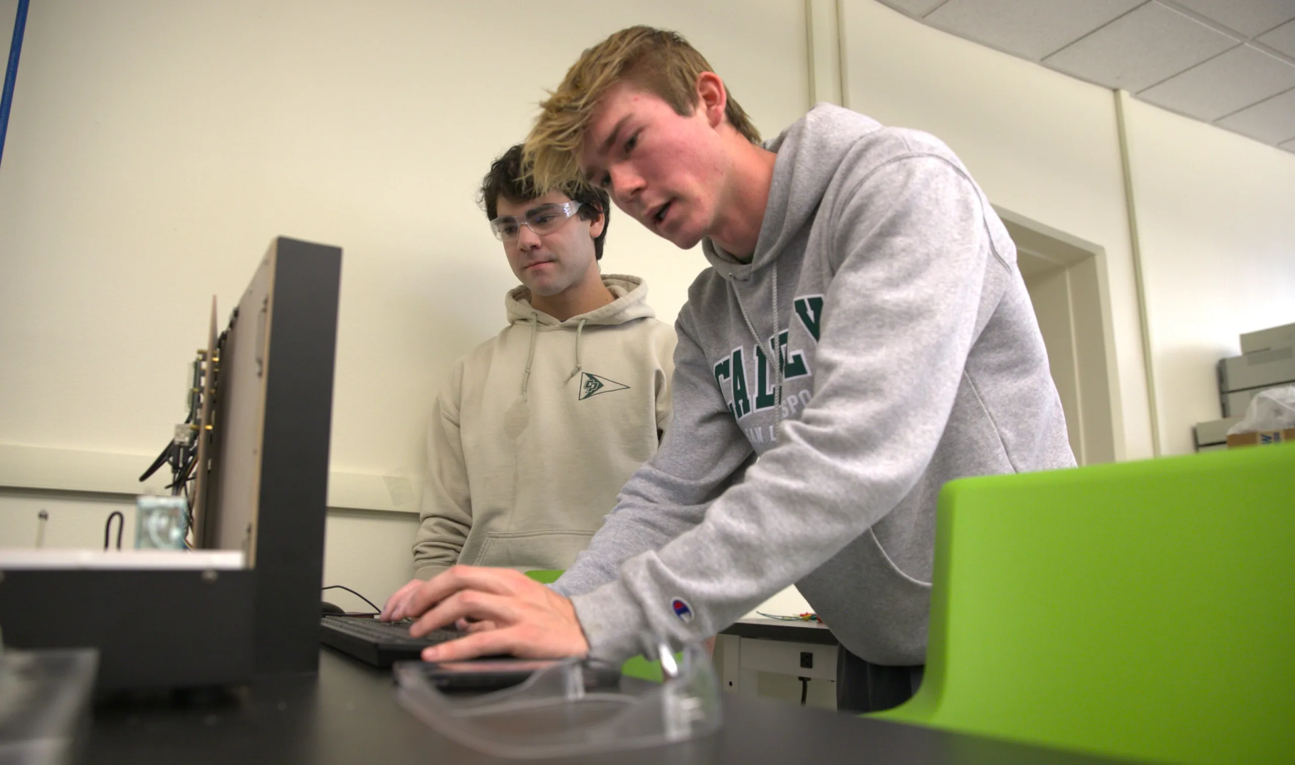 Two students work on a smart mirror they created