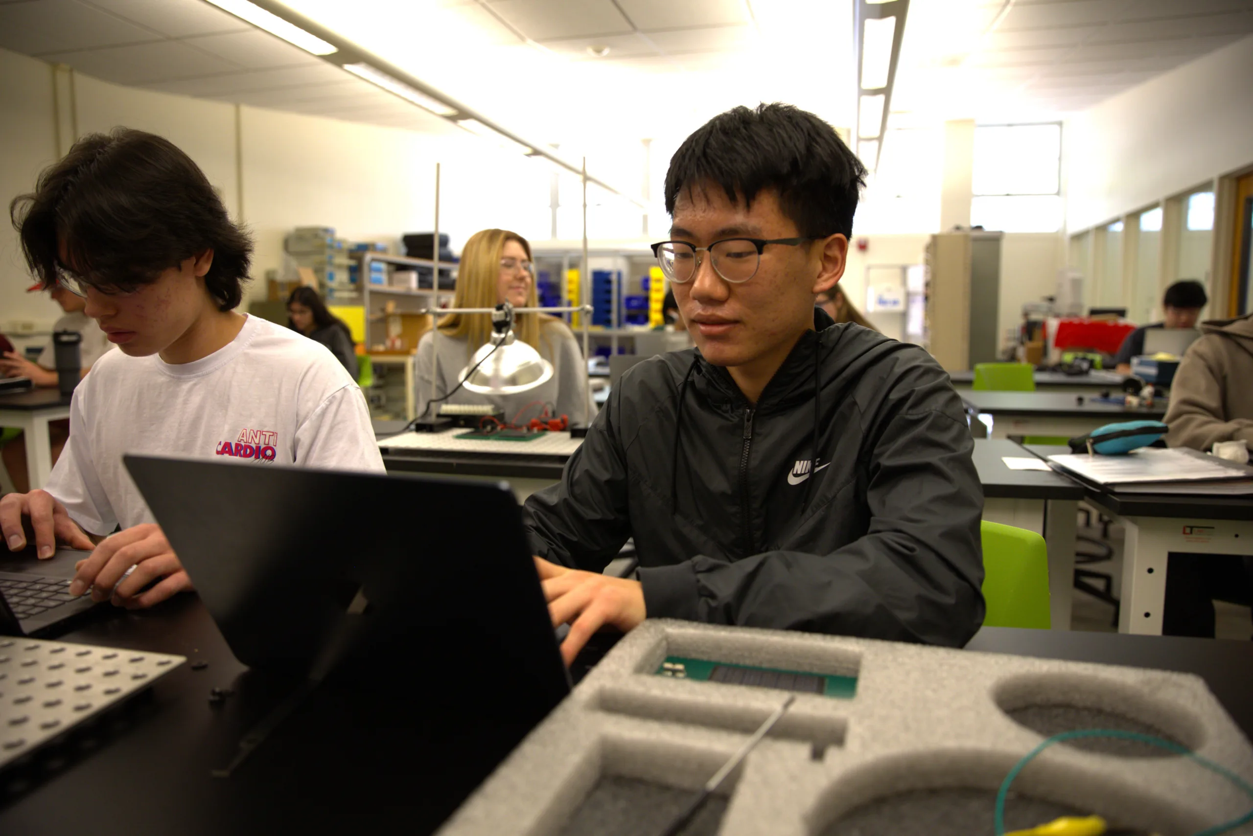 Students work on laptops in a lab