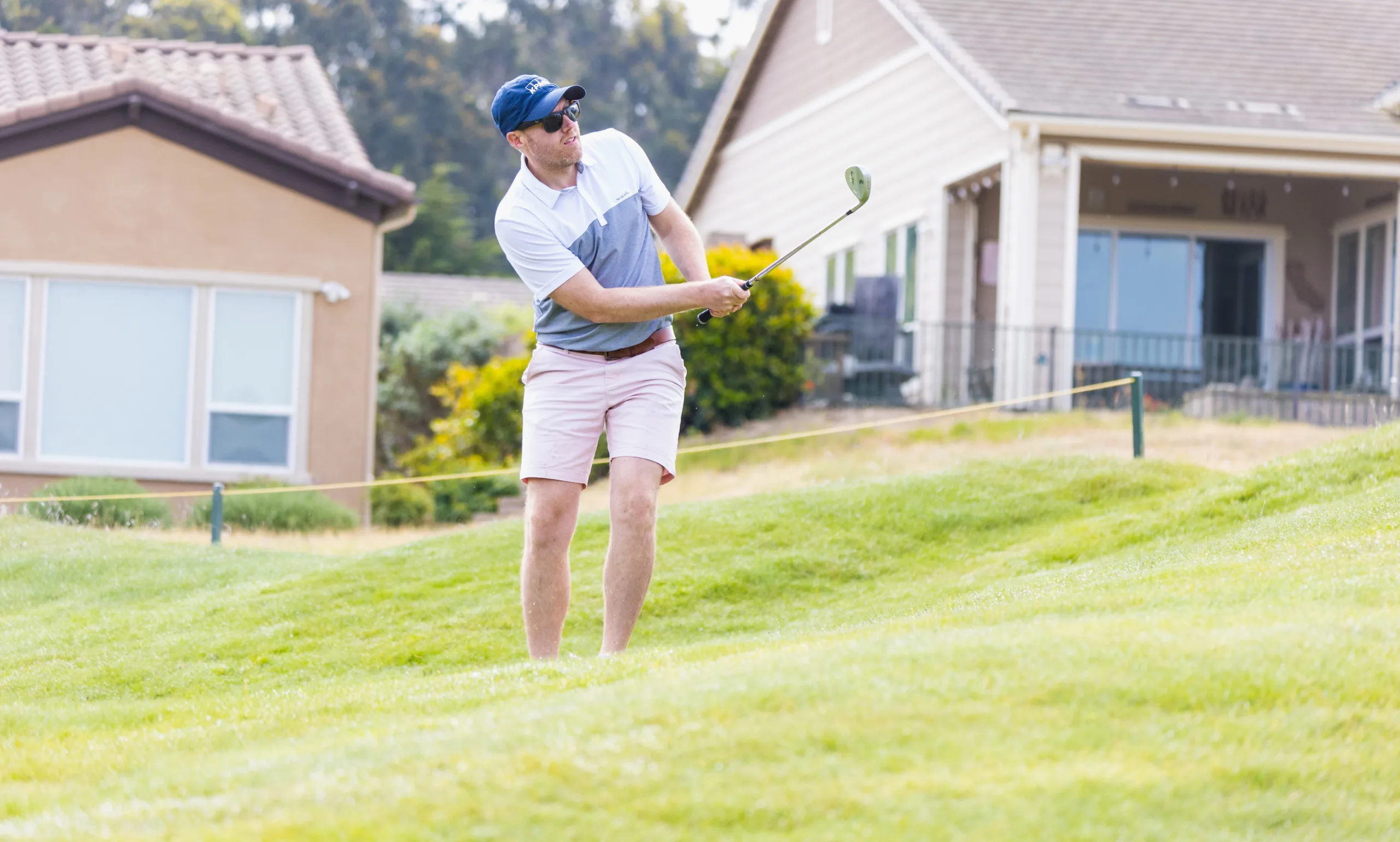 A golfer takes a chip shot