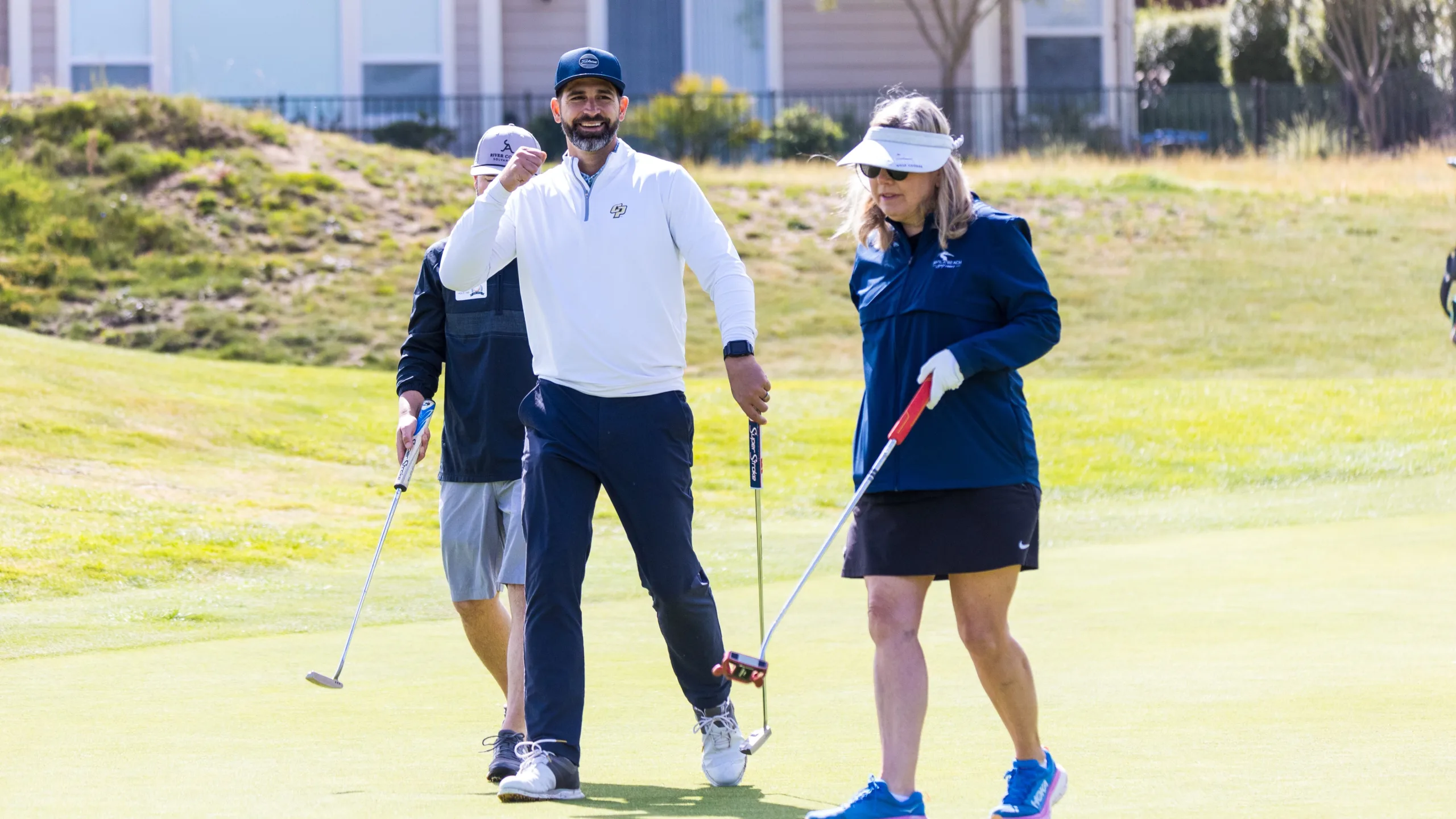 Golfers celebrate a putt