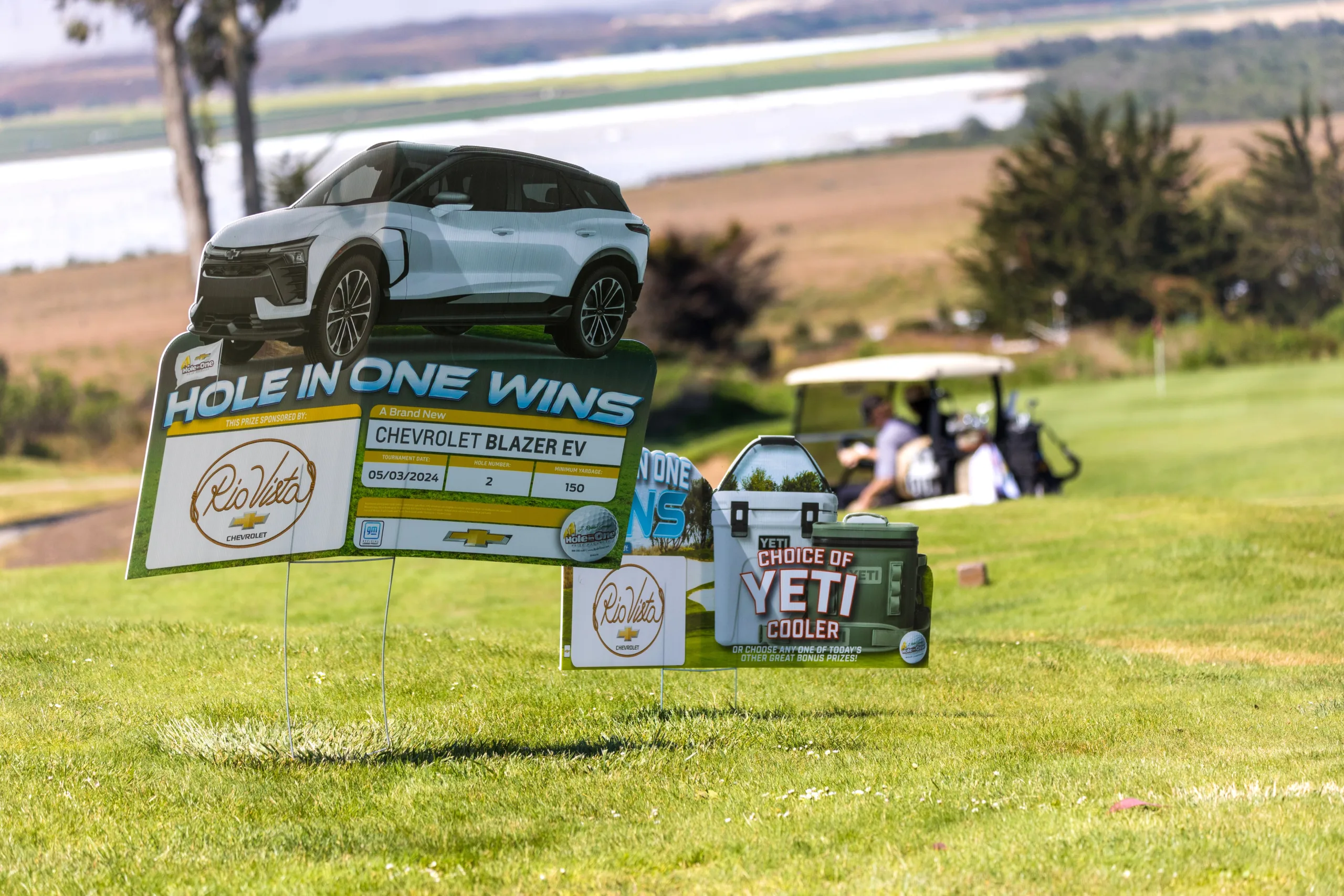 Signs announce a hole-in-one challenge to win a car