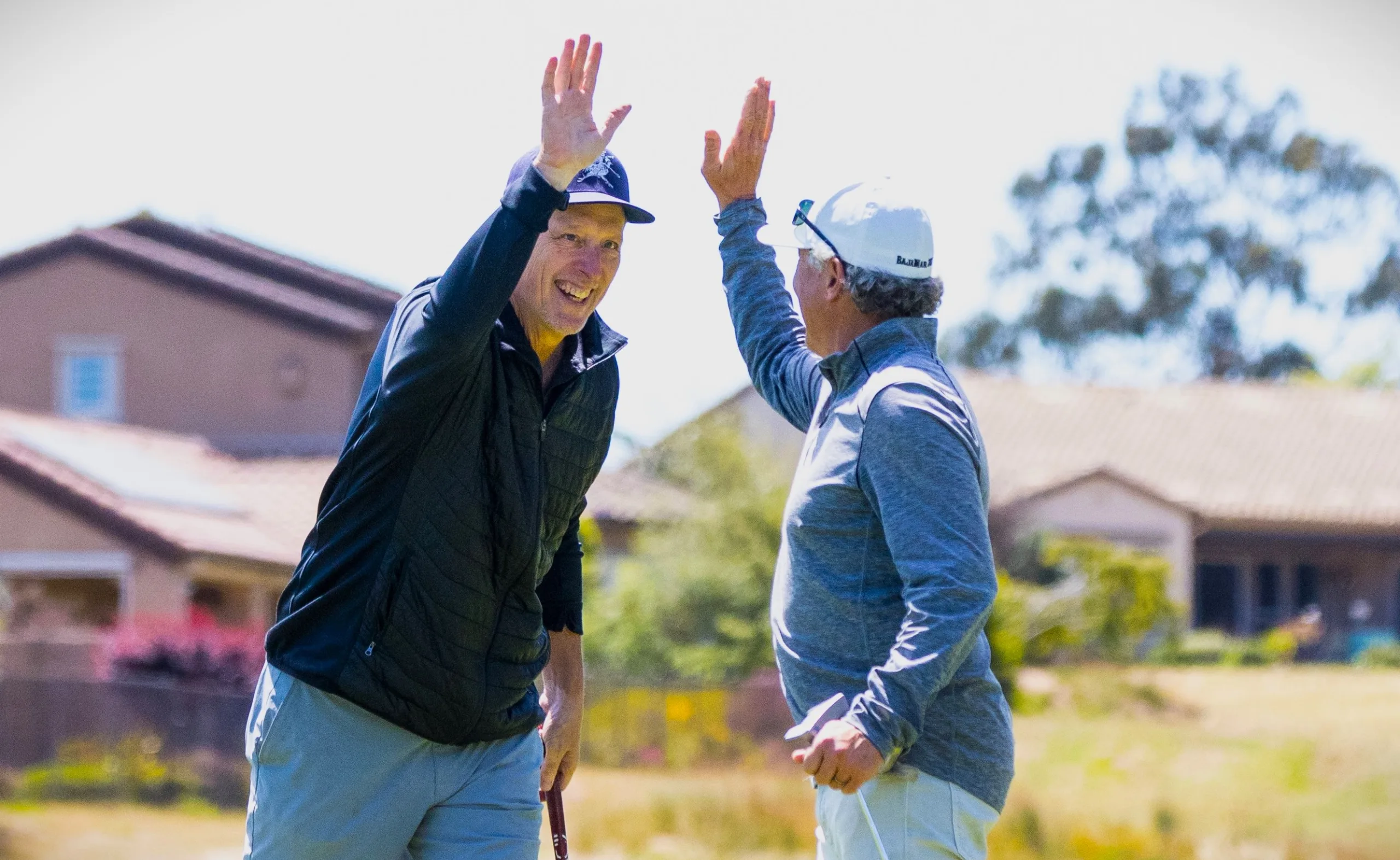 Golfers high five each other