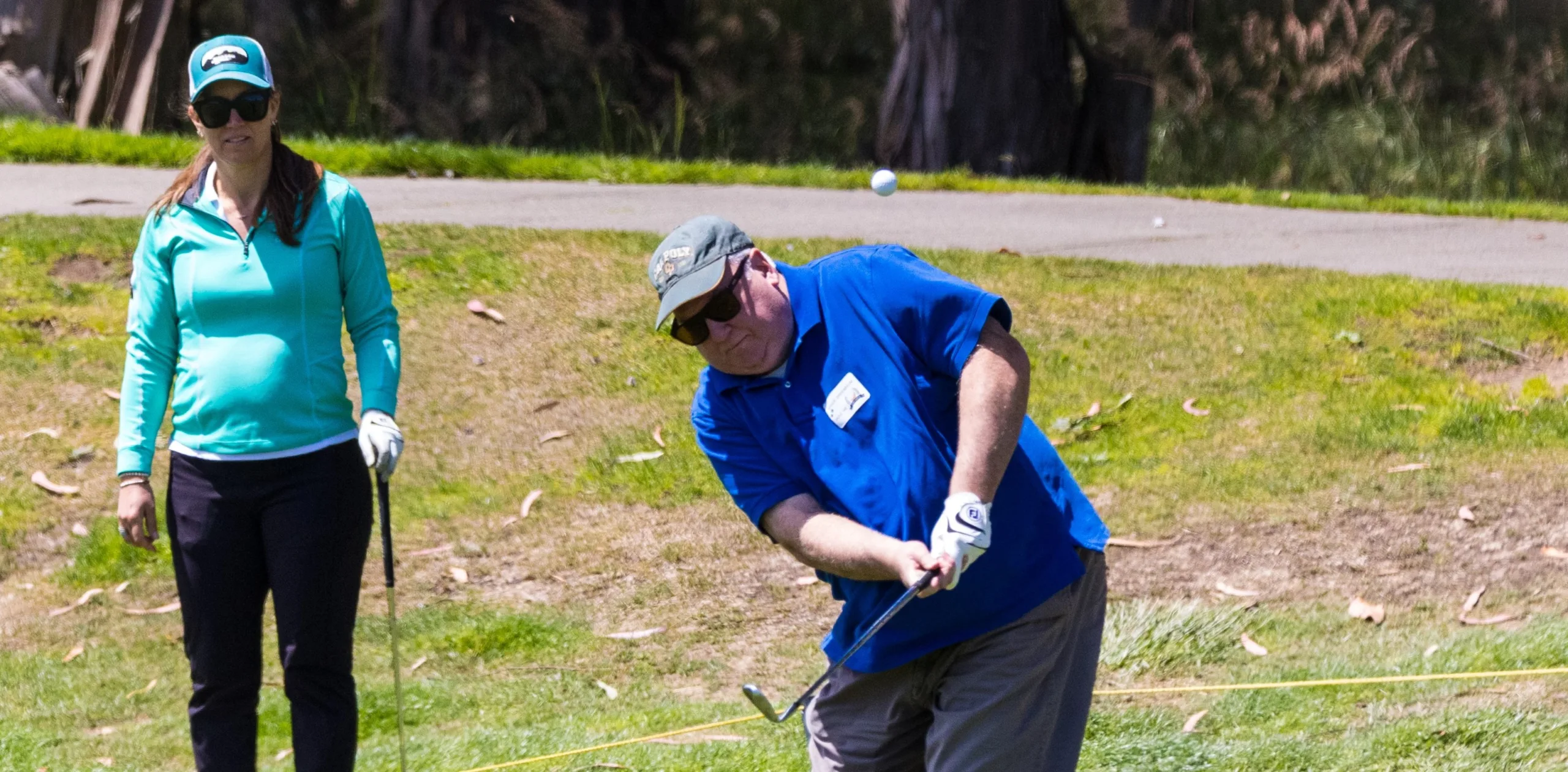 A golfer makes a short shot toward the green