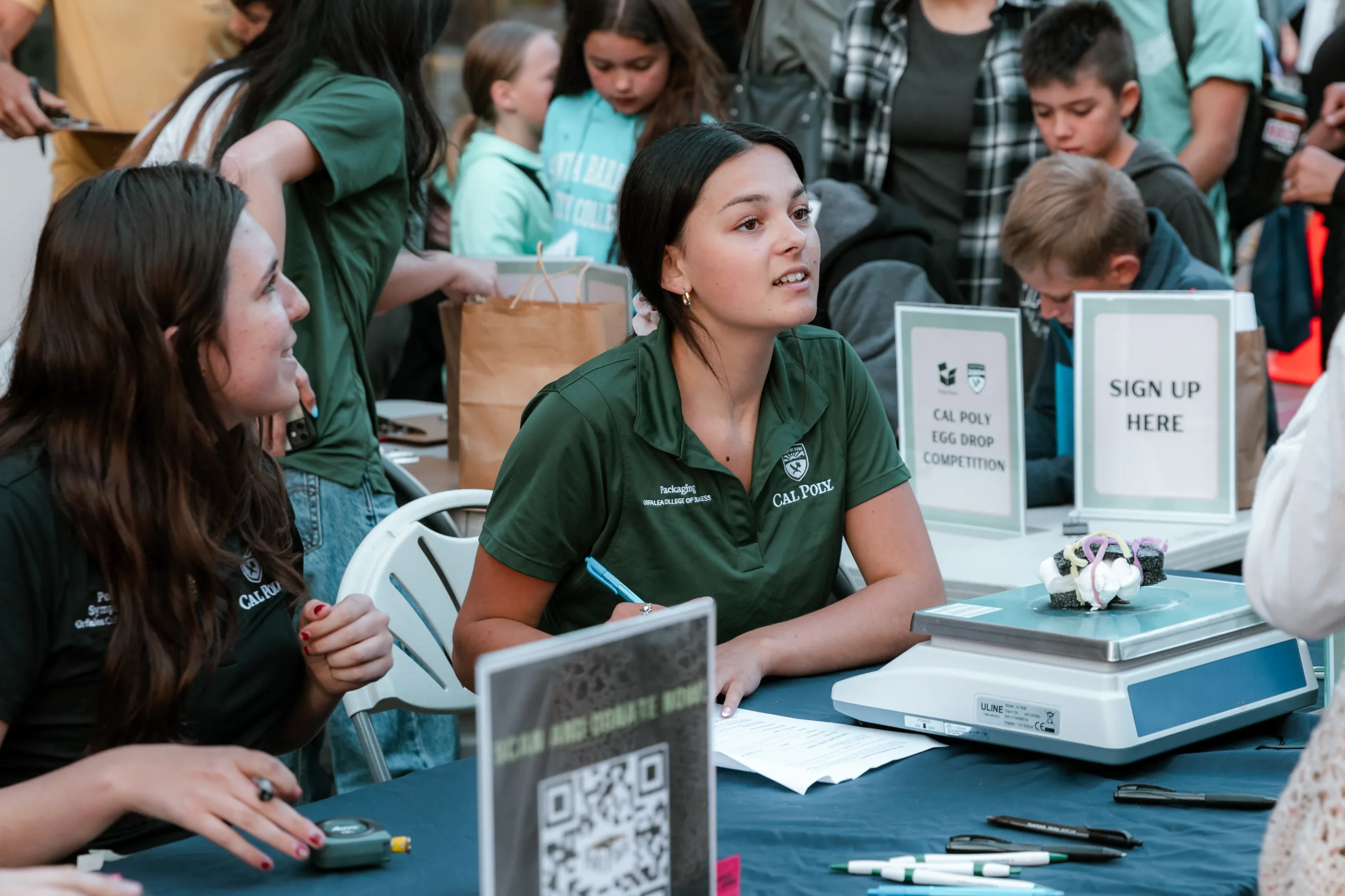 Poly Pack students sign up participants in the egg drop contest