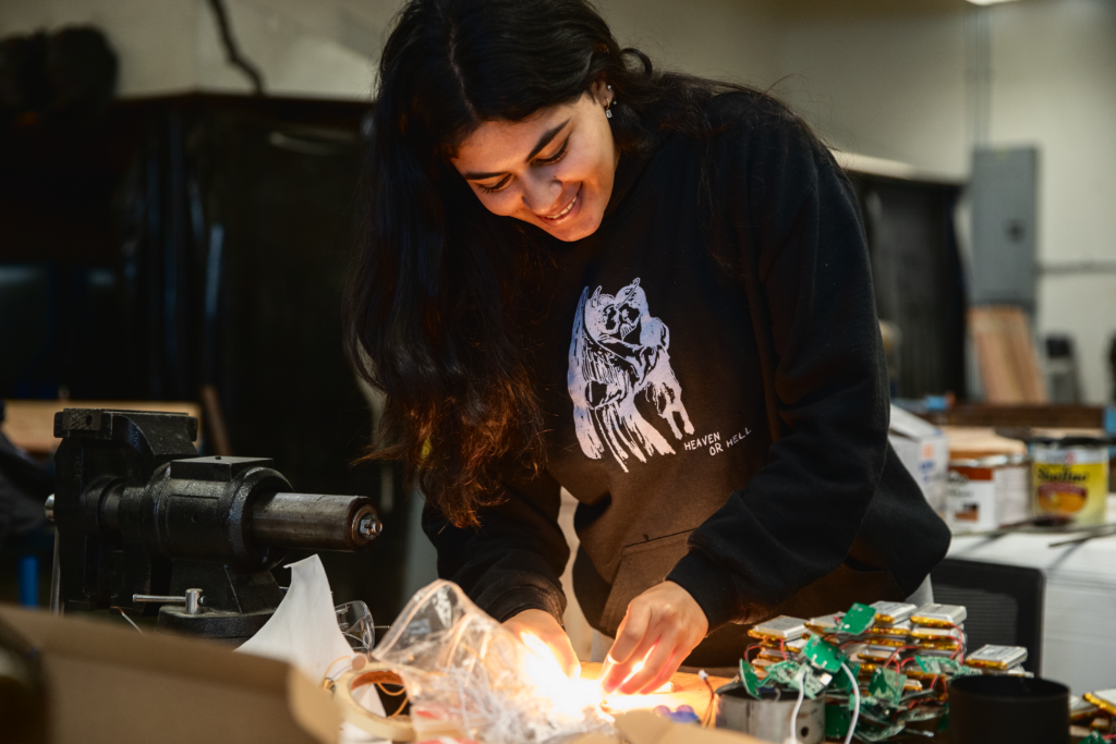 A student works on an LED lilght project in a lab
