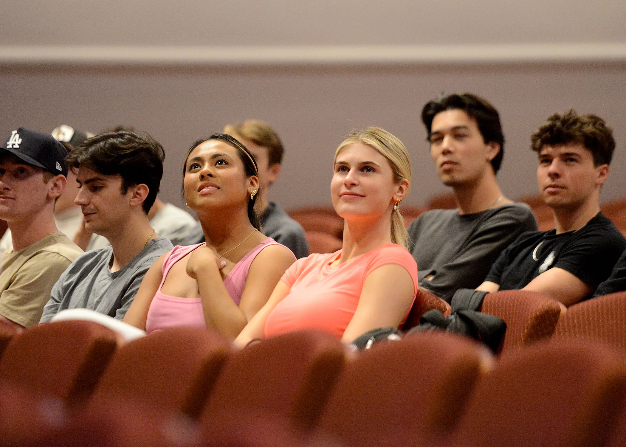 Members of a crowd look up to watch an organist perform