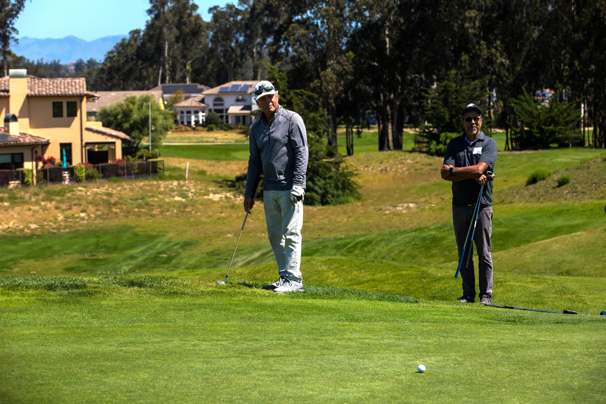 A golfer watches his putt