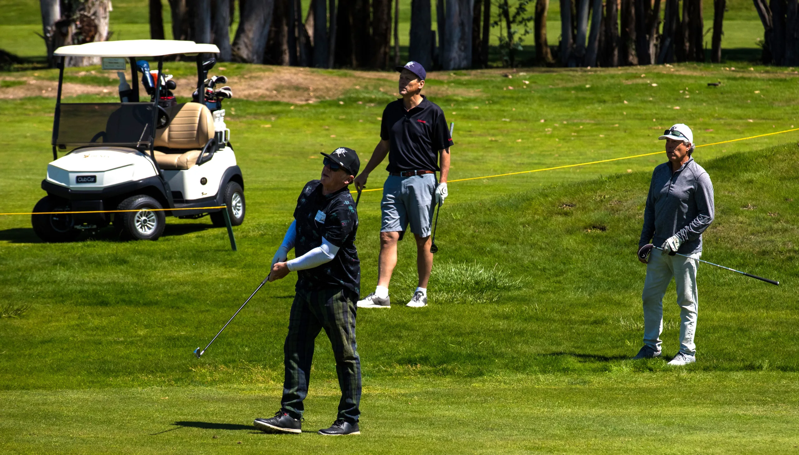 A golfer hits the ball on the fairway