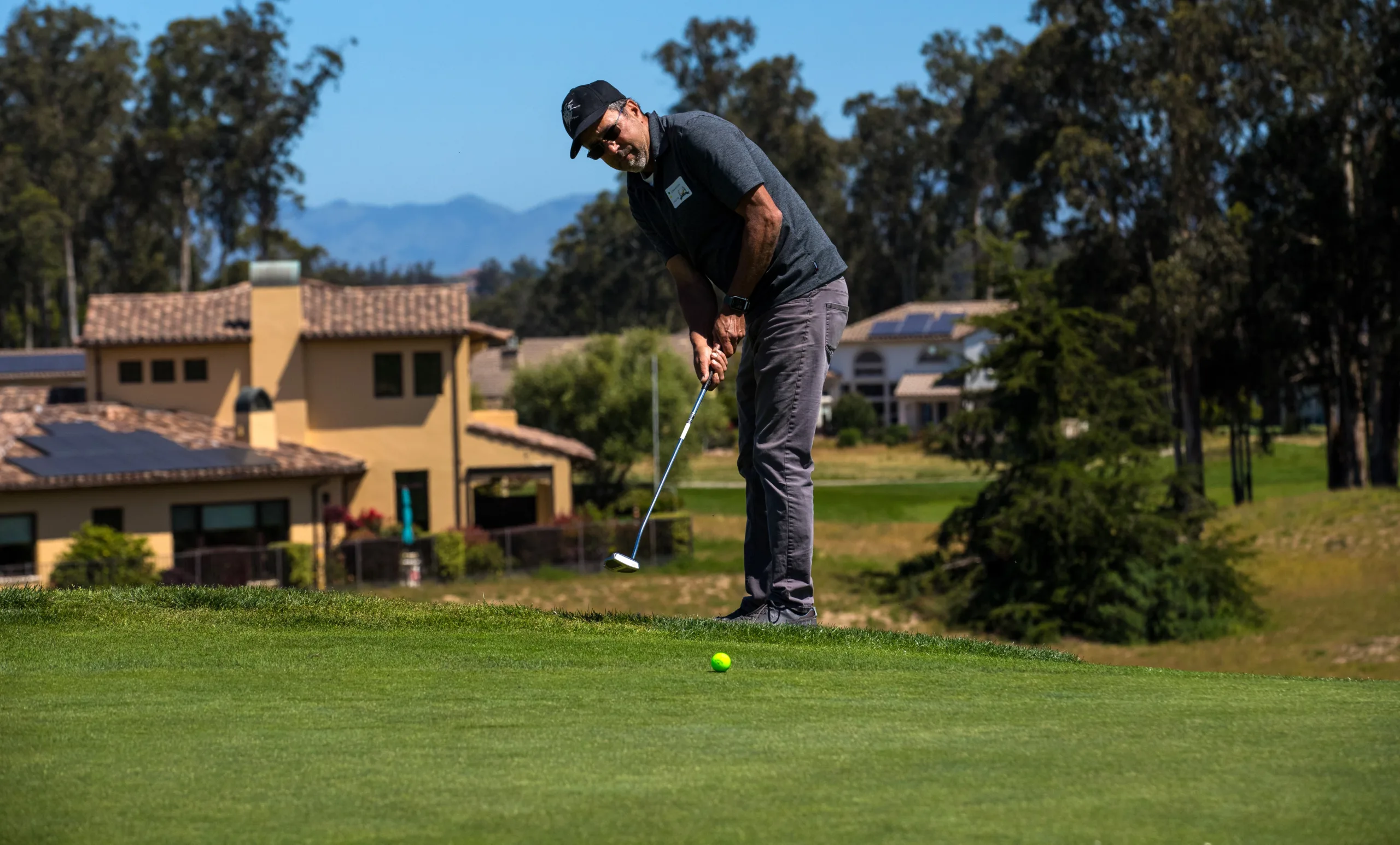 A golfer putts