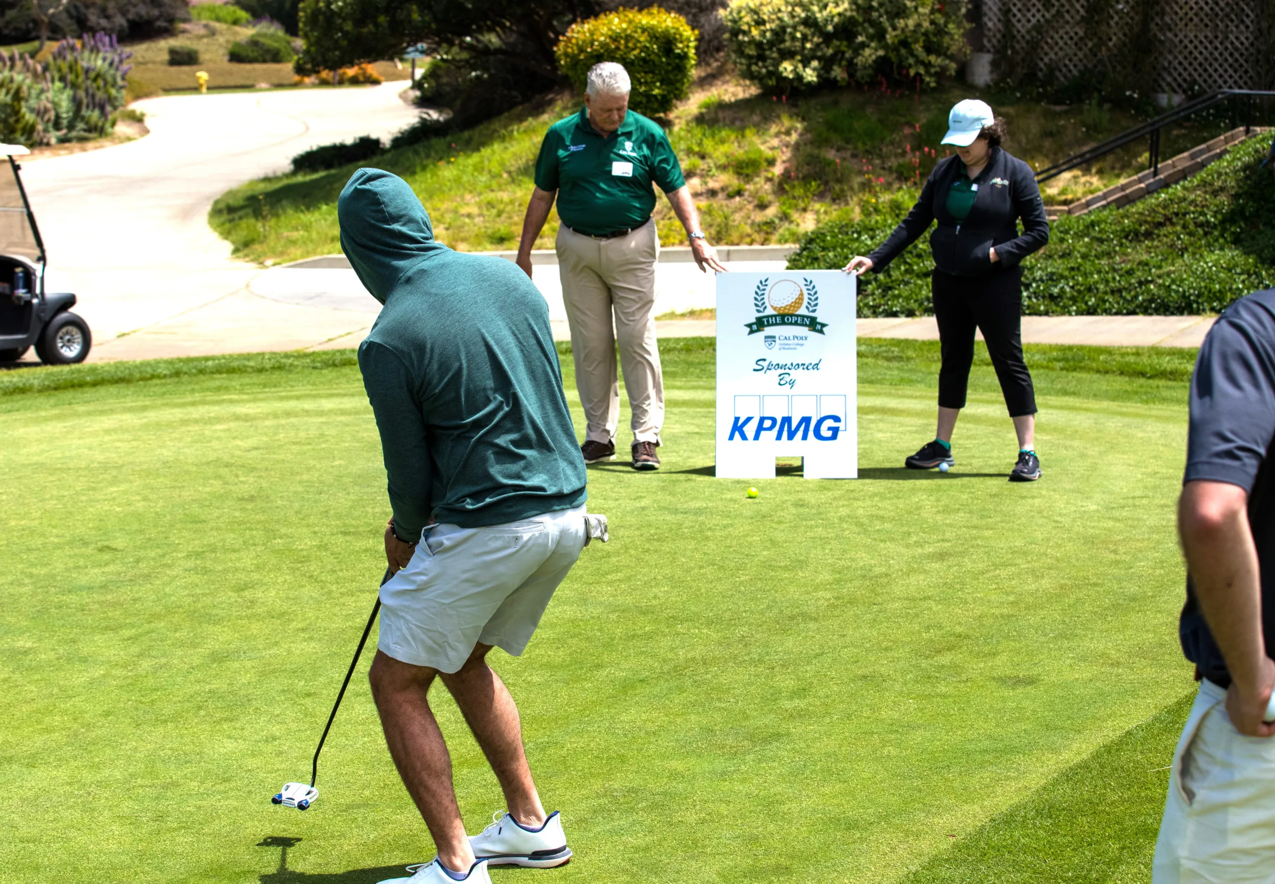 A golfer putts during a contest