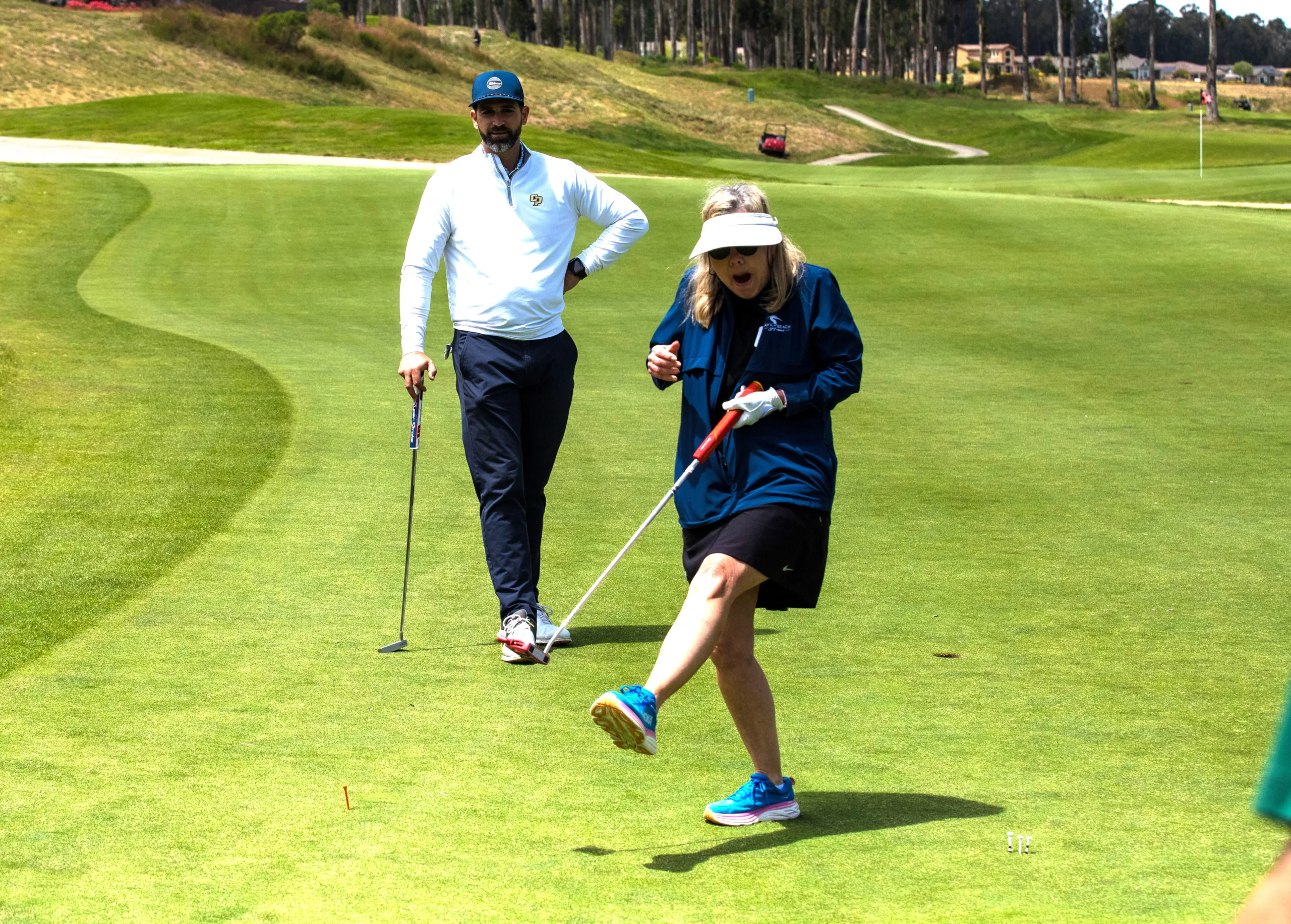 A golfer celebrates a putt