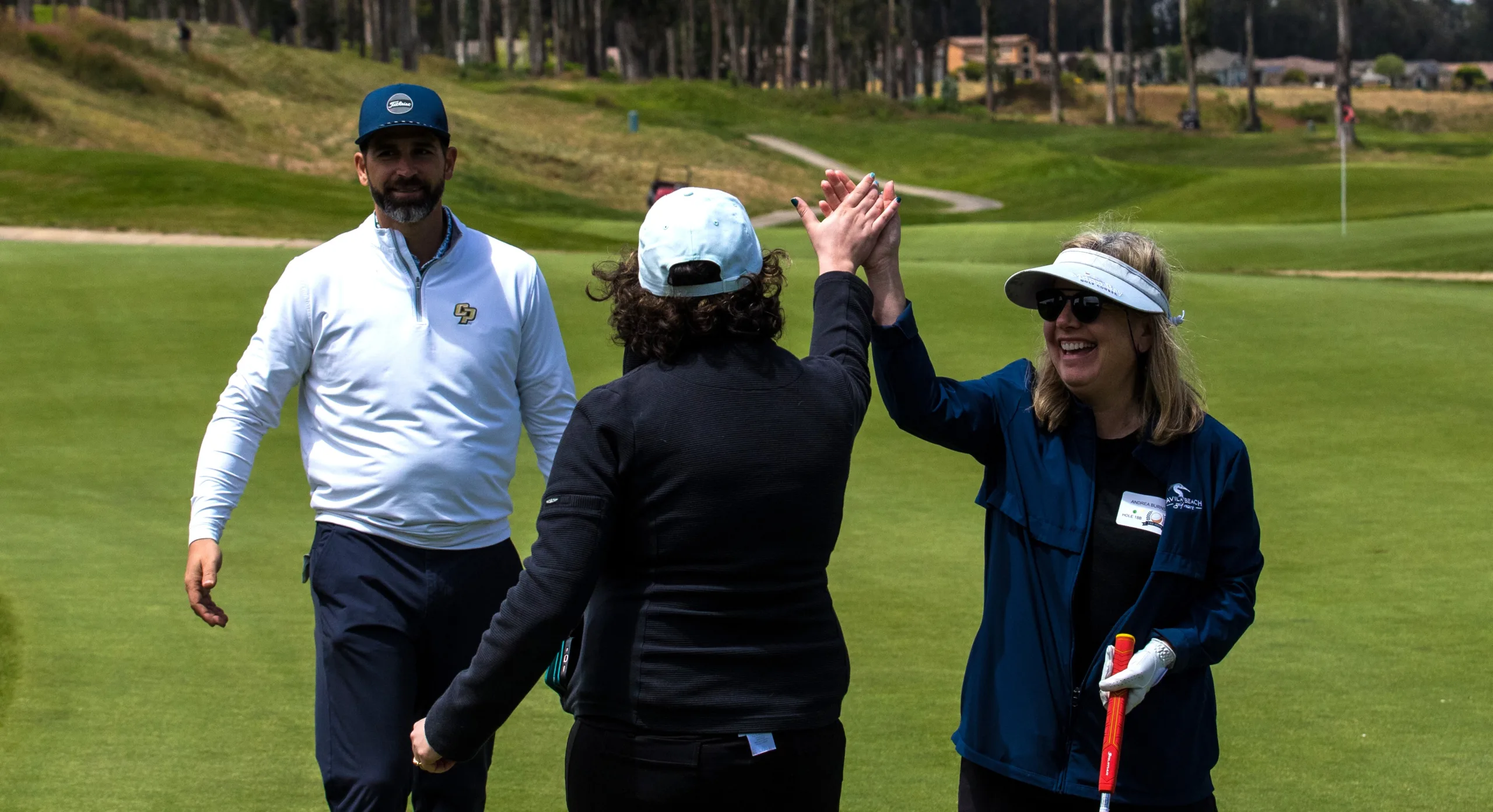 A golfer celebrates a putt