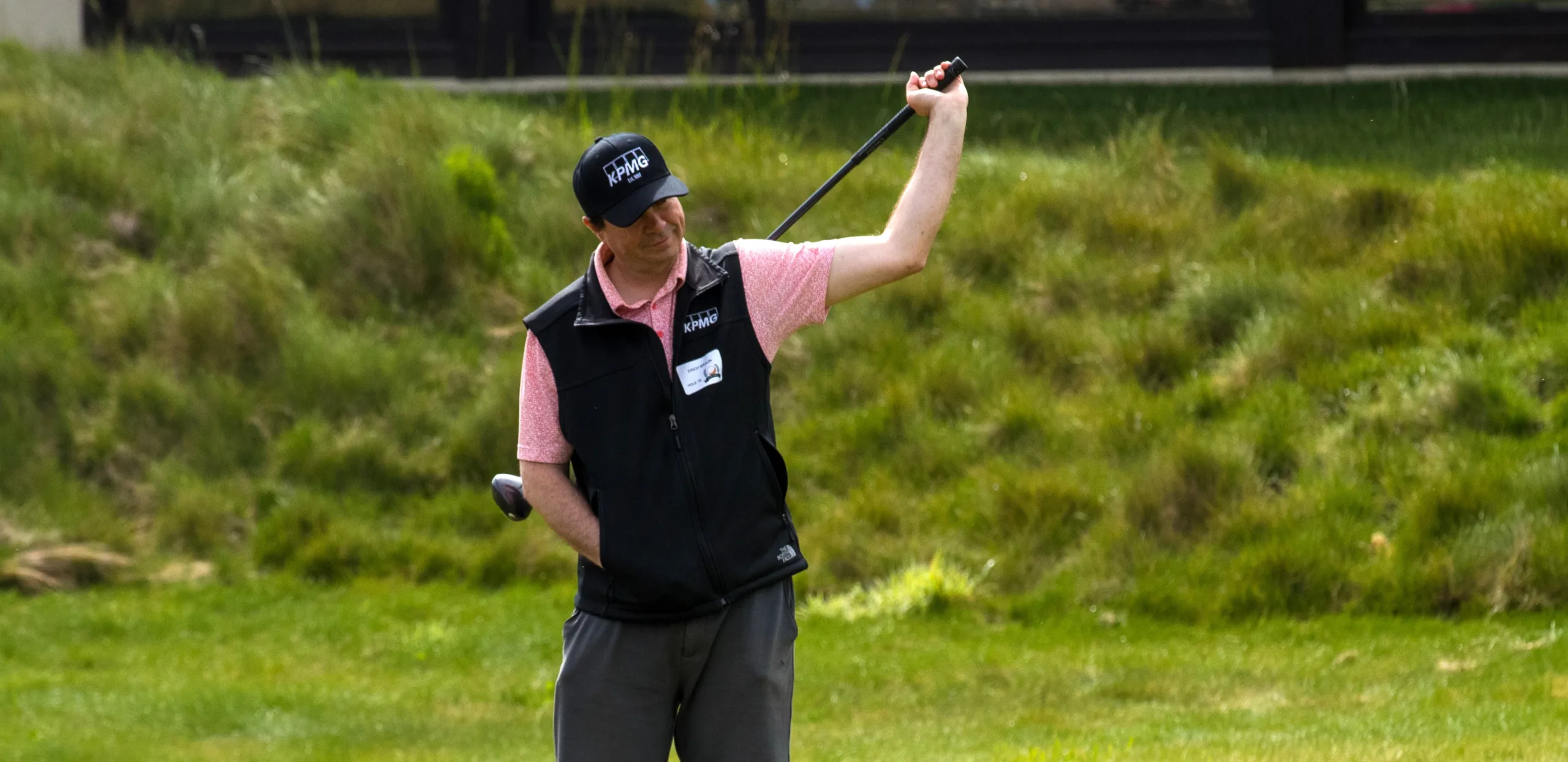 a golfer stretches with his club