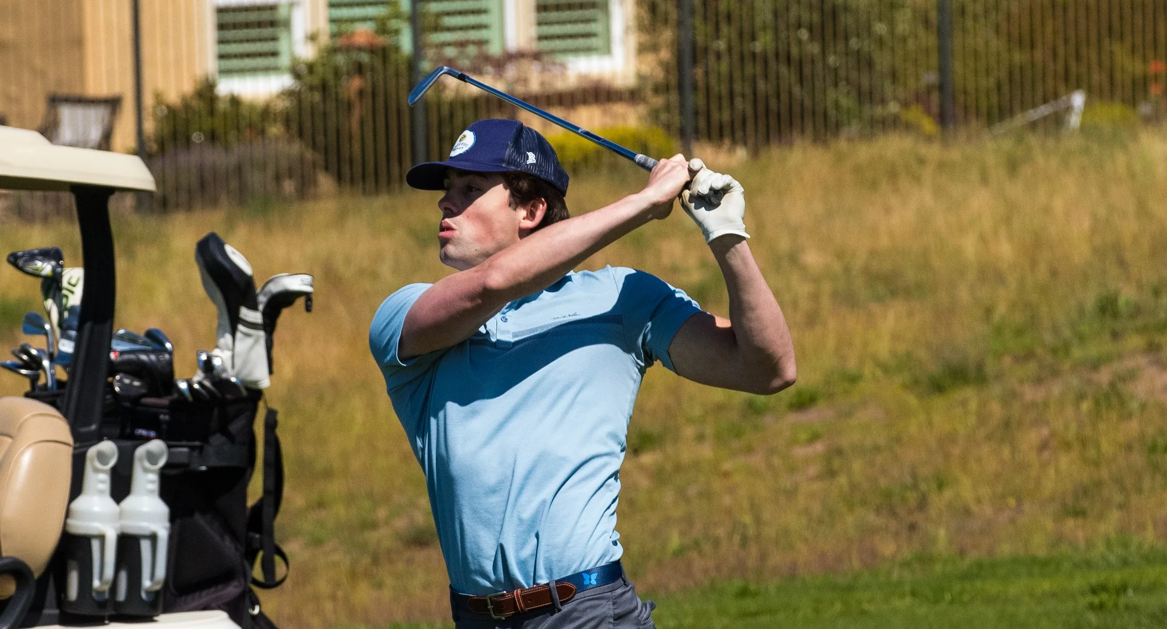 a golfer drives off the tee