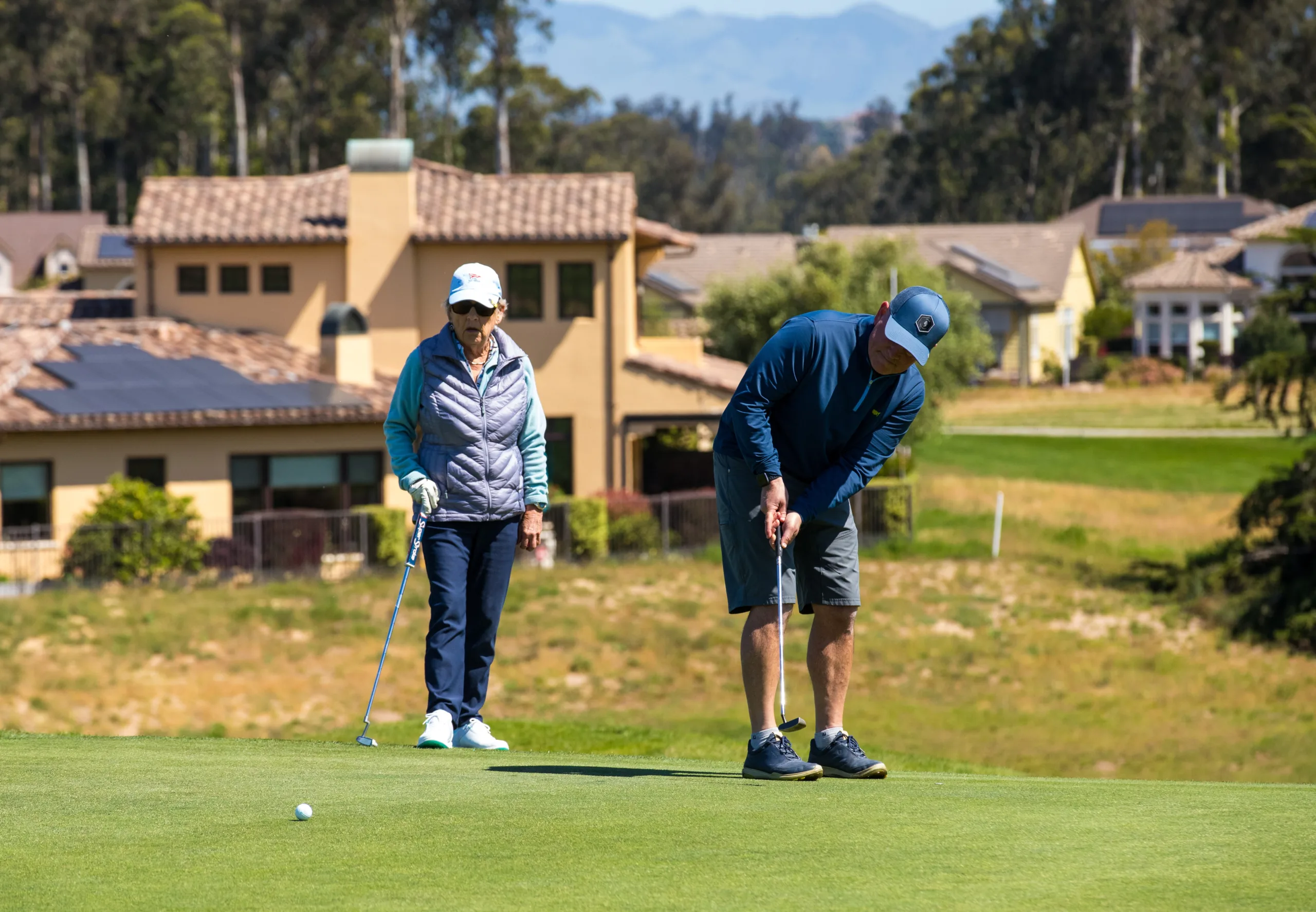 A golfer putts the ball