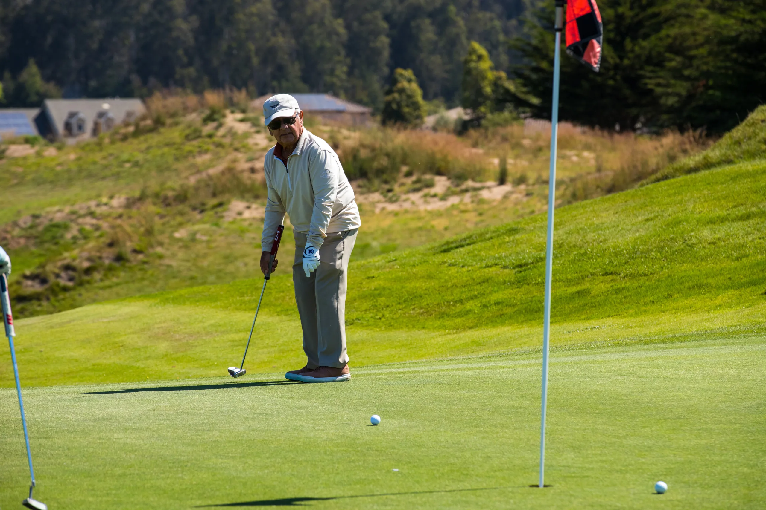 A golfer watches his putt